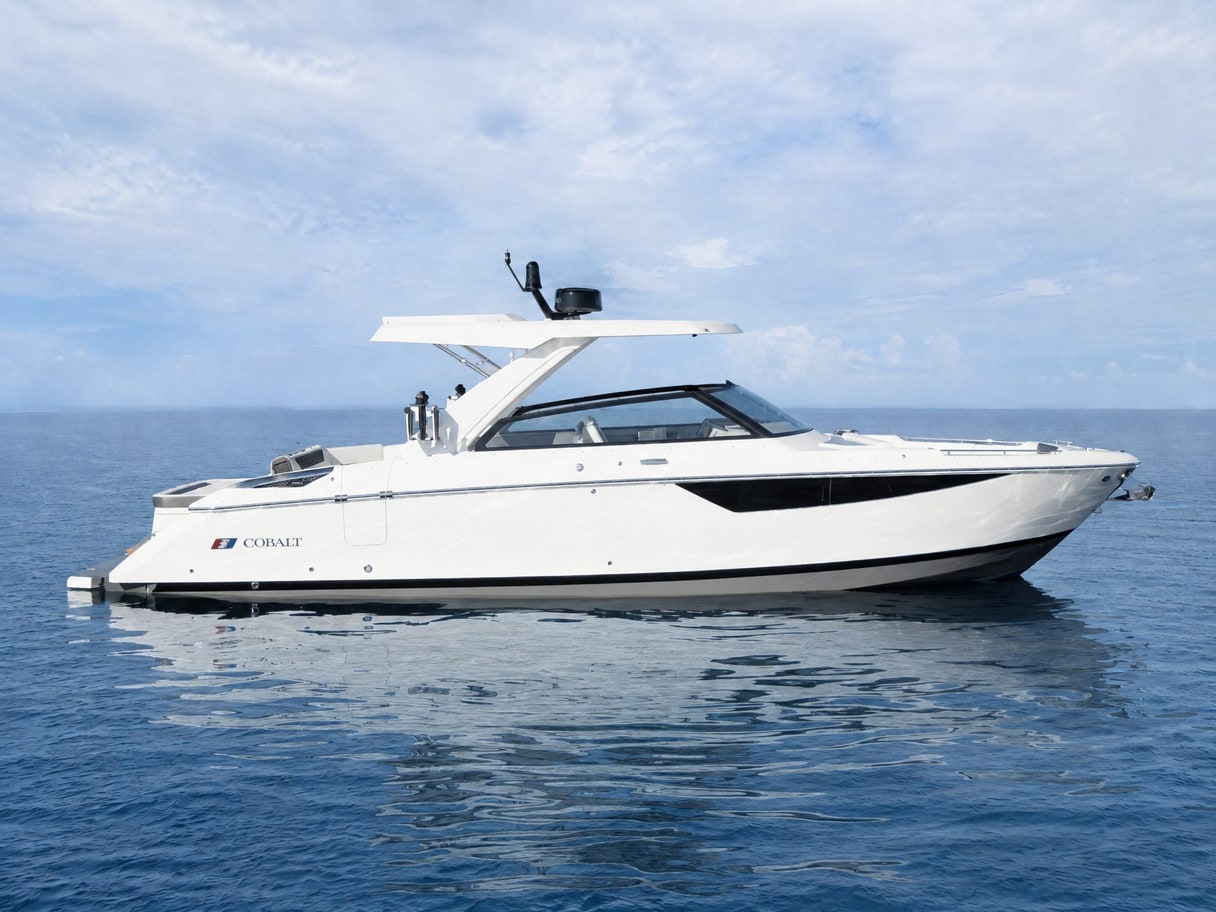 The same Cobalt on open blue water under a soft cloudy sky, with no land in view.