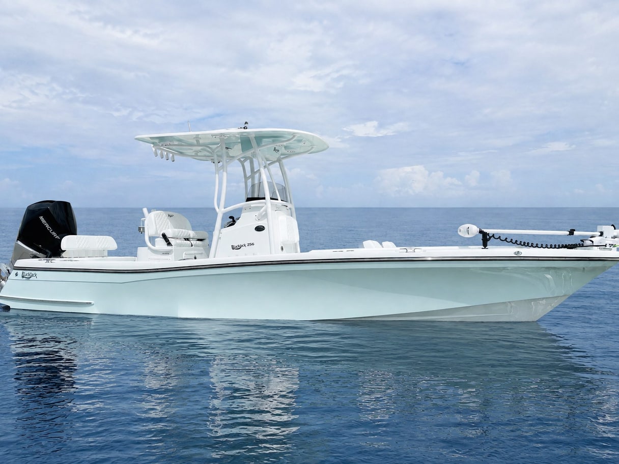 The same Blackjack on calm open water under a pale sky.